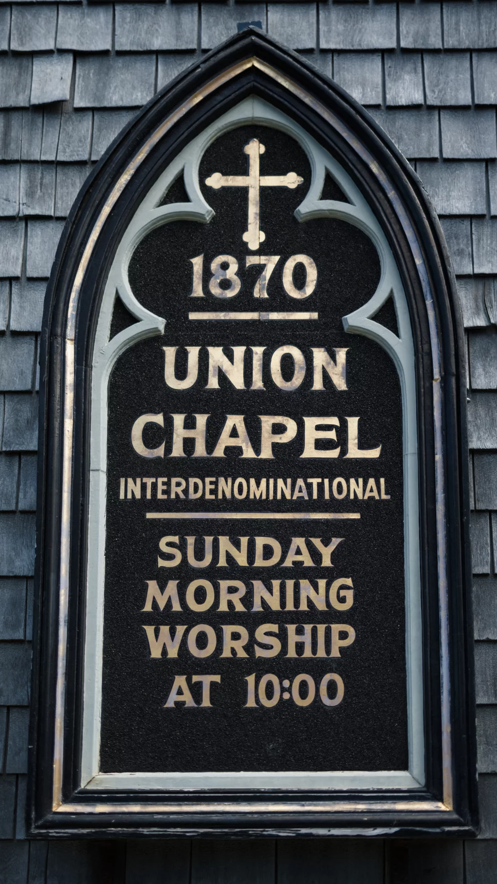 : Gothic-style church sign reading "1870 Union Chapel Interdenominational Sunday Morning Worship at 10:00" with a cross above the text.