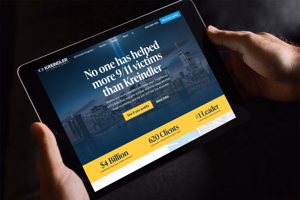 Aviation lawyer Kreindler marketing materials: Tablet screen showing the Kreindler law firm website homepage with headline "No one has helped more 9/11 victims than Kreindler," a NYC skyline background, and statistics about clients and settlements at the bottom; held by two hands against a dark background.
